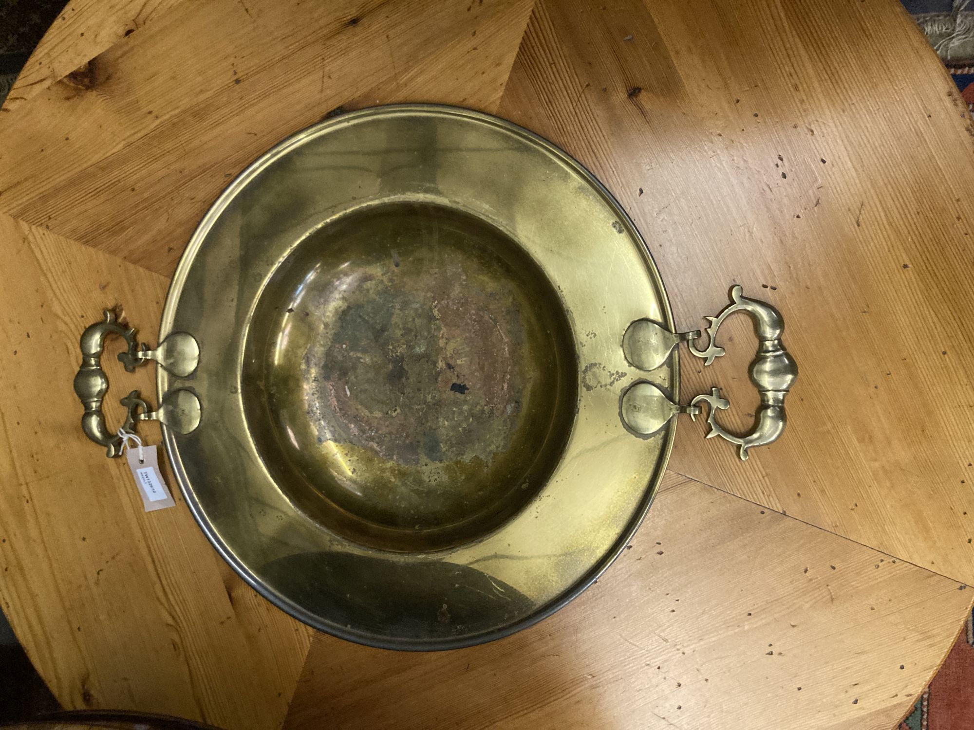 A circular pine low table inset two-handled brass brazier, diameter 108cm height 43cm